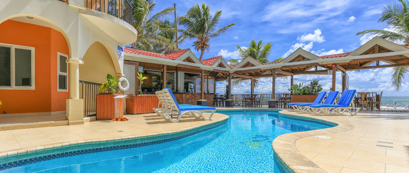 The oceanfront pool, restaurant and suites at SunBreeze Suites